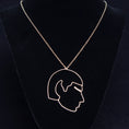 Load image into Gallery viewer, Necklace with a pendant of a profiled Mr. Spock on a black velvet stand against a dark background