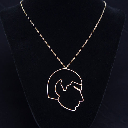 Necklace with a pendant of a profiled Mr. Spock on a black velvet stand against a dark background